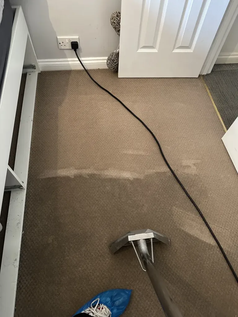 Carpet cleaning London technician using hot water extraction machine